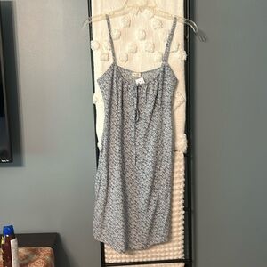 Mini summer dress with blue and white floral pattern and gathered bodice.